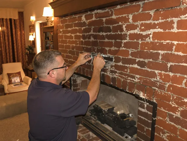 Fort Collins Chimney Sweep expert fixing a fireplace in Fort Collins, CO